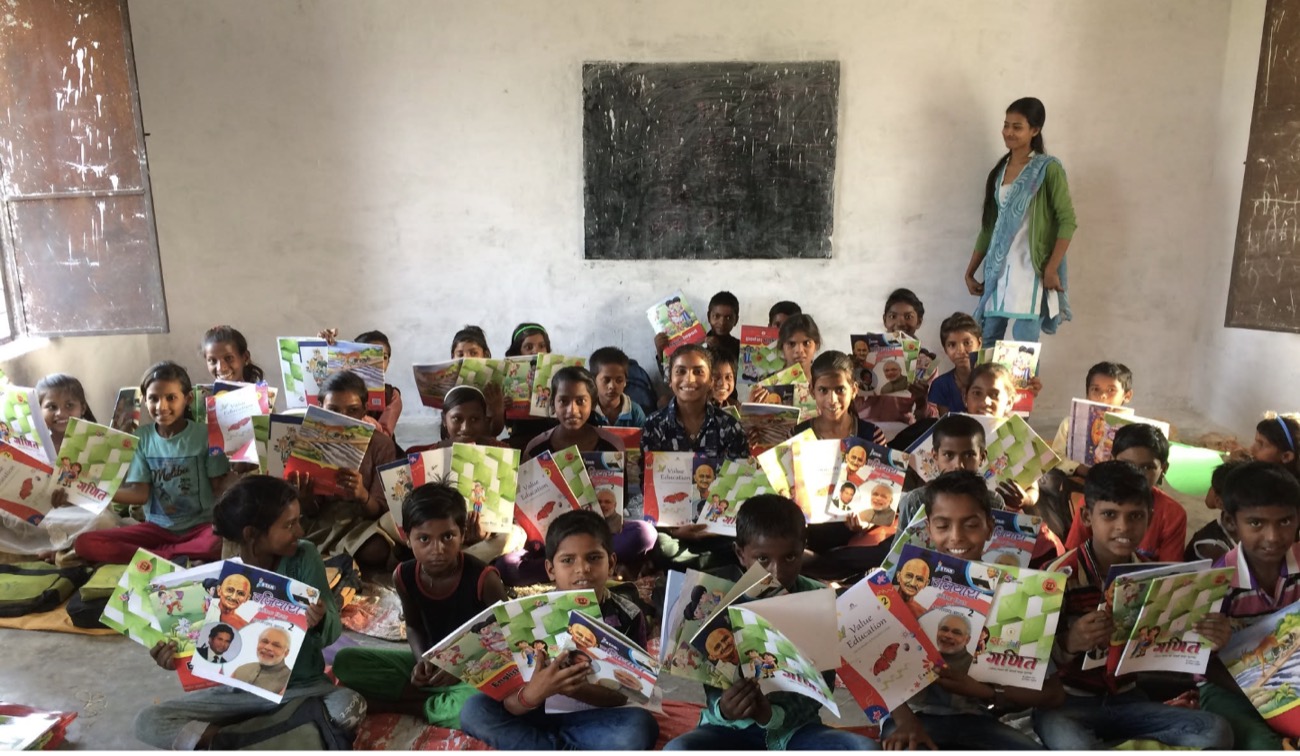 A fellow's classroom, workbooks in hand