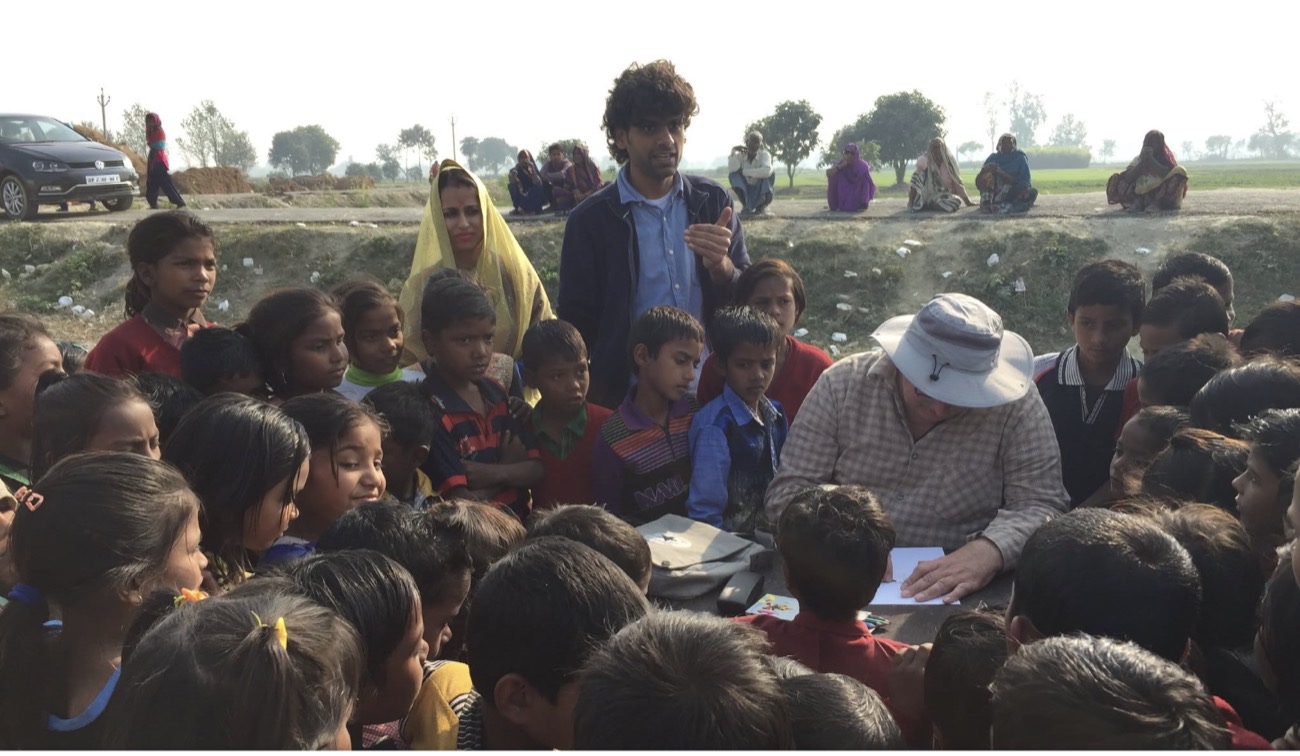 A visiting volunteer teaching a crowd of children