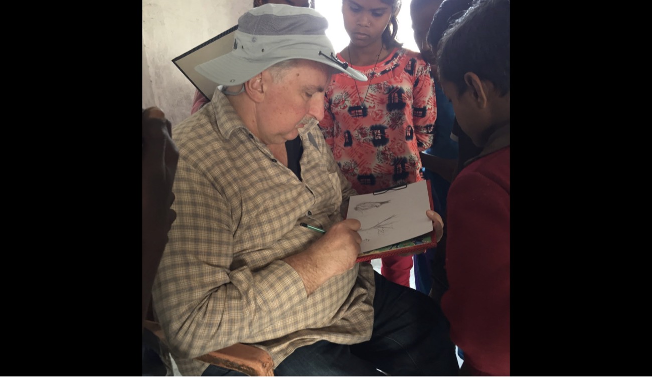 A volunteer teaching a sketching technique